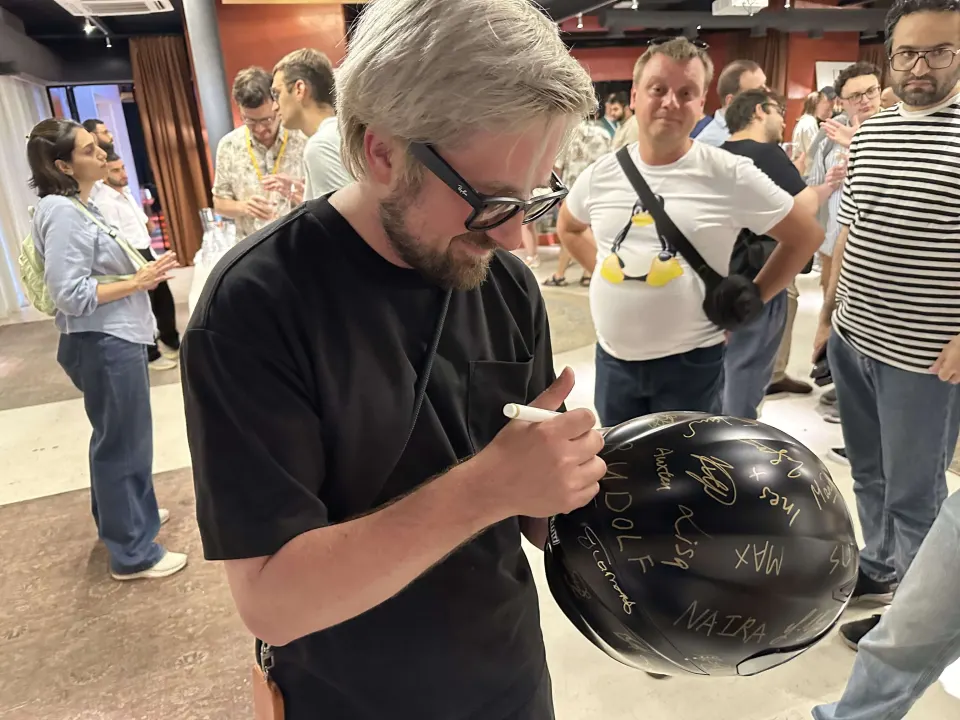 A speaker signing the helmet